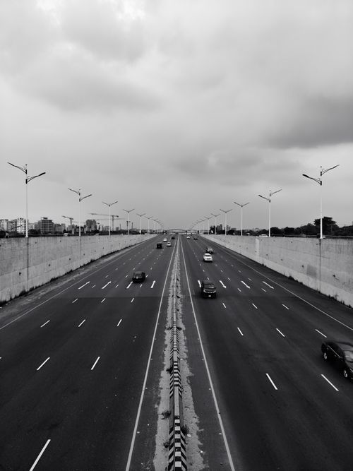 Free Black and white image of a highway with cars under an overcast sky, taken from above. Stock Photo