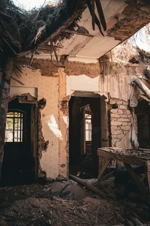 Free Interior view of an abandoned building with exposed walls and debris. Stock Photo