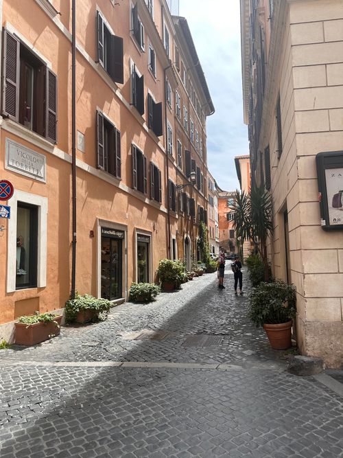 Free Cobblestone street in Rome's historic center with typical Italian architecture and morning light. Stock Photo