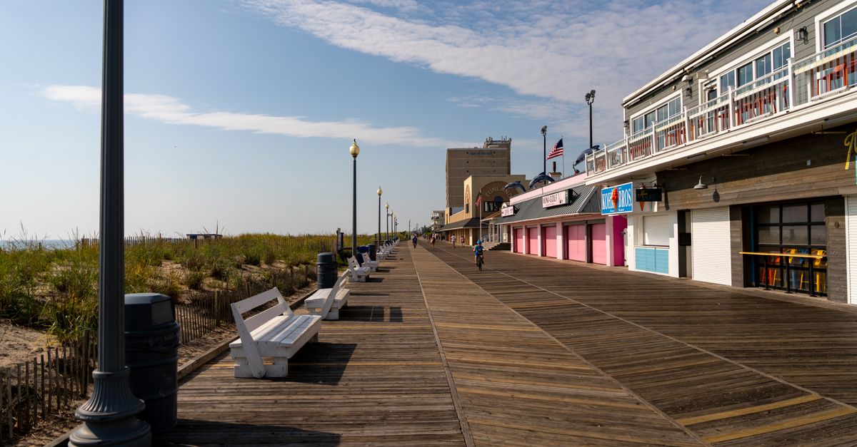 A sunny day on the famous Rehoboth Beach boardwalk in Delaware, capturing serenity and architecture.