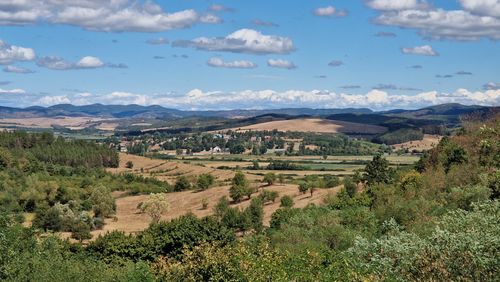 Free Panoramic view of lush countryside with rolling hills and a clear blue sky. Stock Photo