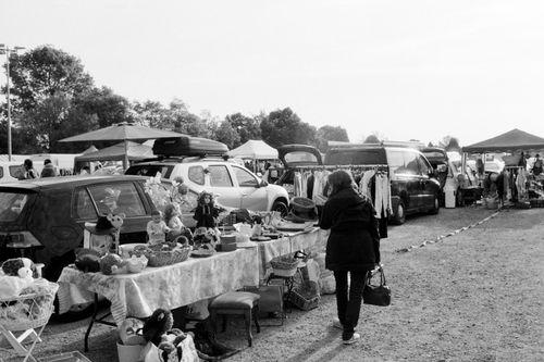 Free Black and white outdoor street market scene with people and stalls. Stock Photo