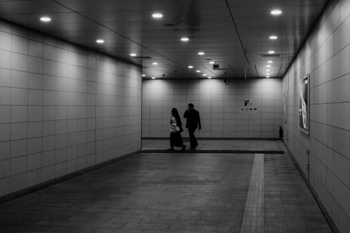 Free Dramatic black and white shot of people walking in a subway tunnel in Vietnam, capturing urban life. Stock Photo