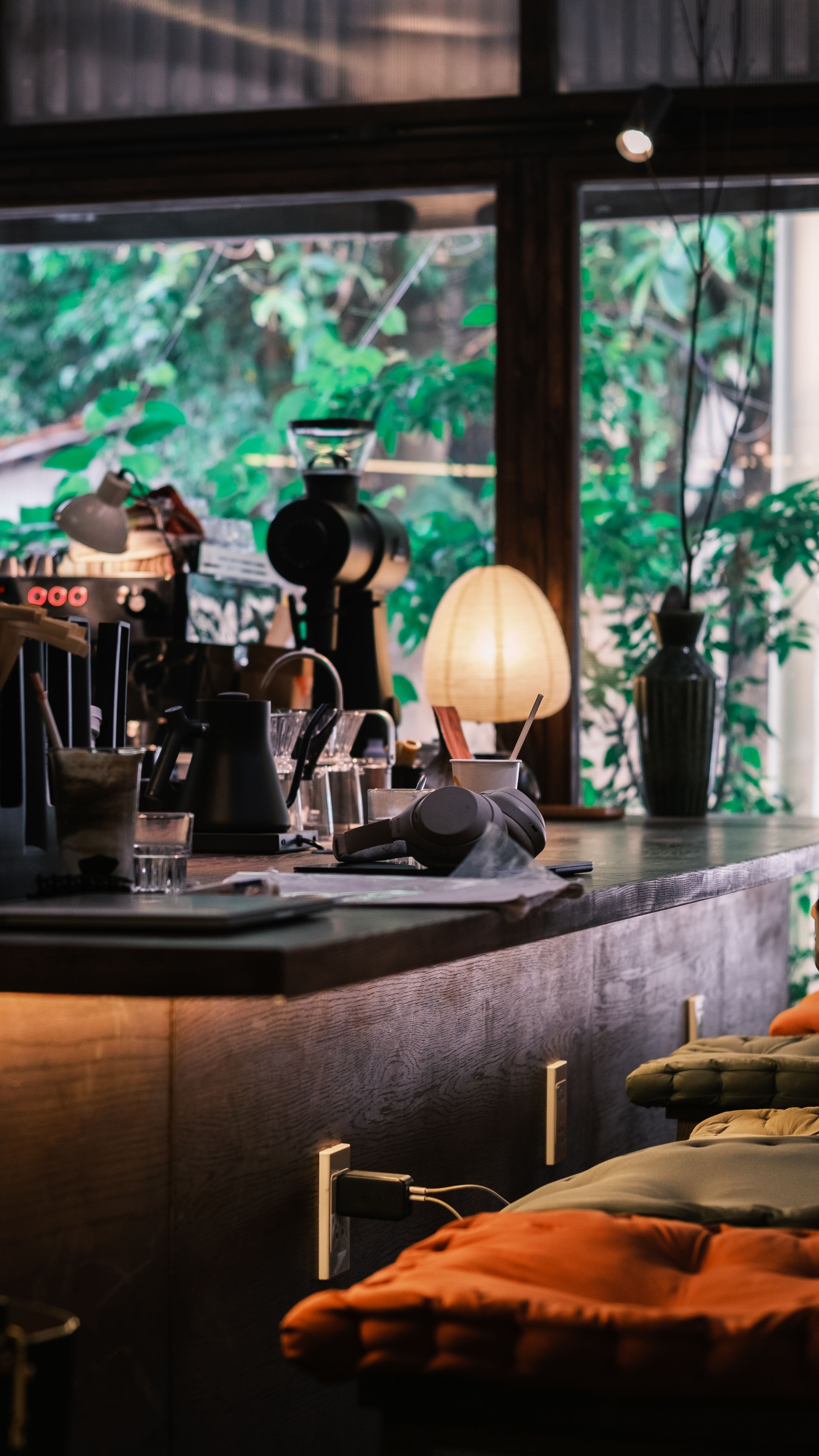 Adjustable gooseneck task lamp positioned on a counter next to a pour-over coffee setup