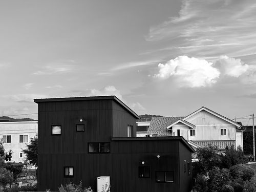 Free Monochrome image of modern and traditional suburban houses under a partly cloudy sky. Stock Photo