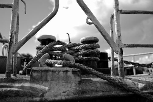 Free Black and white photo of ropes tied on a boat deck, showcasing maritime elements. Stock Photo