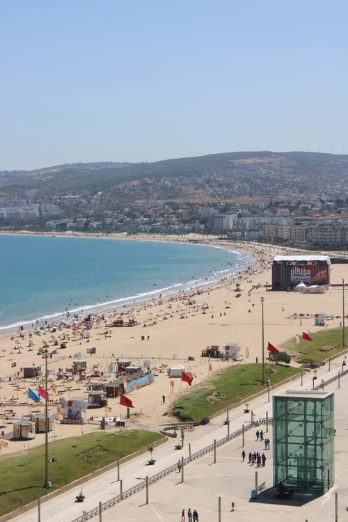 Free Aerial view of Tangier Beach, Morocco, bustling with people under a clear blue sky. Stock Photo