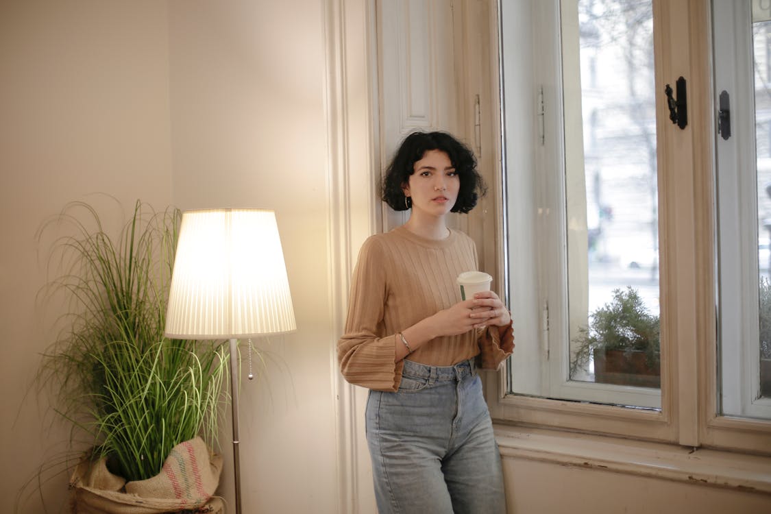 Photo Of Woman  Standing Beside Window