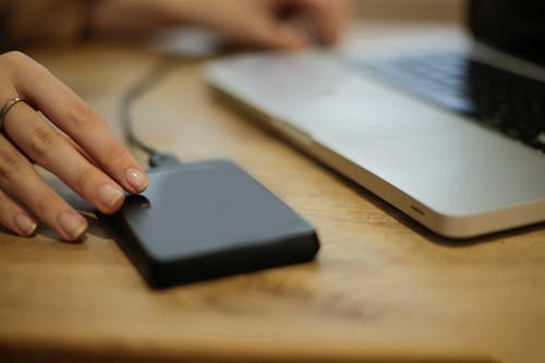 Free Black Square Device on Brown Wooden Table Stock Photo