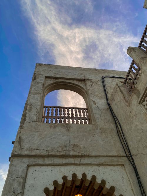Free Authentic Emirati architecture with a blue sky backdrop, showcasing traditional design in Dubai. Stock Photo