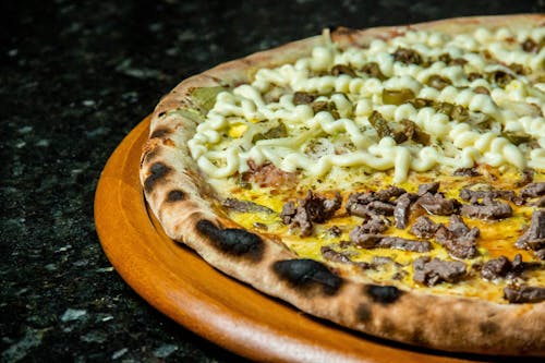 Pizza With Cheese and Green Leaves