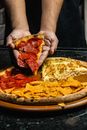 Person Holding Pizza With Red Sauce
