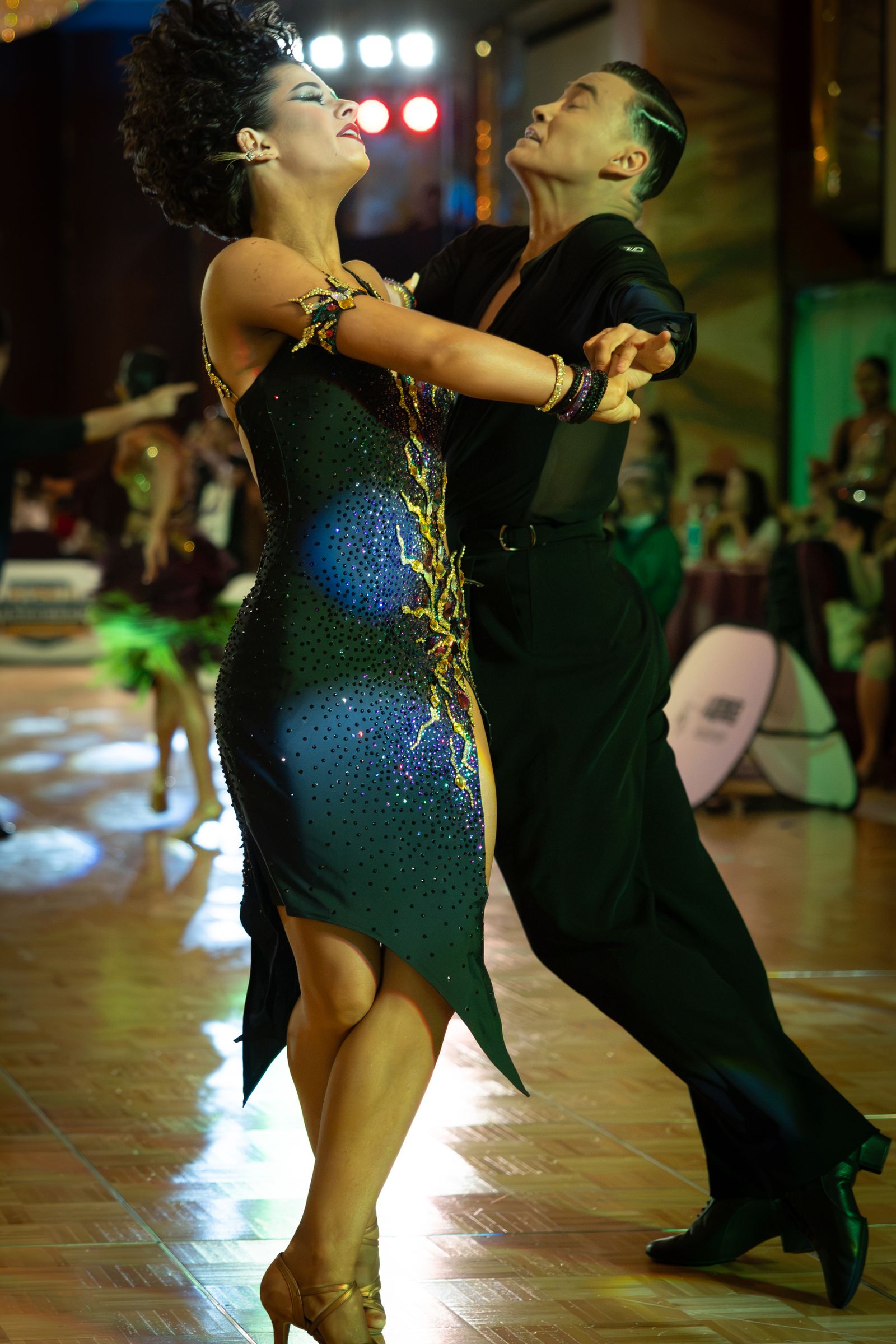 International Latin — competition Latin couple in a black rhinestone dress. Stock photo.
