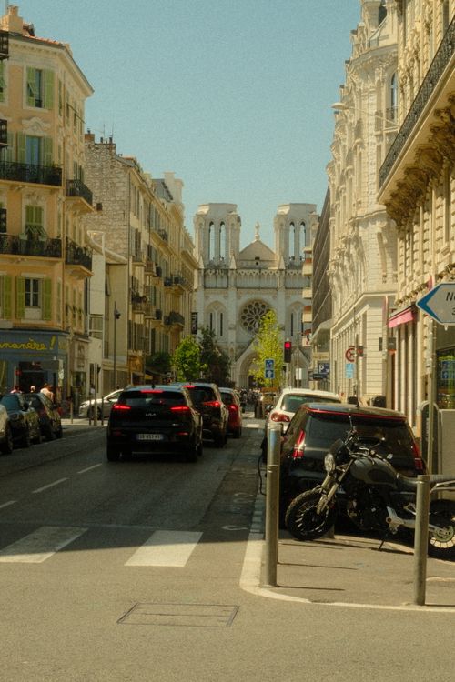 Free Scenic street view of the Basilica of Notre-Dame in Nice, France, under a clear sky. Stock Photo