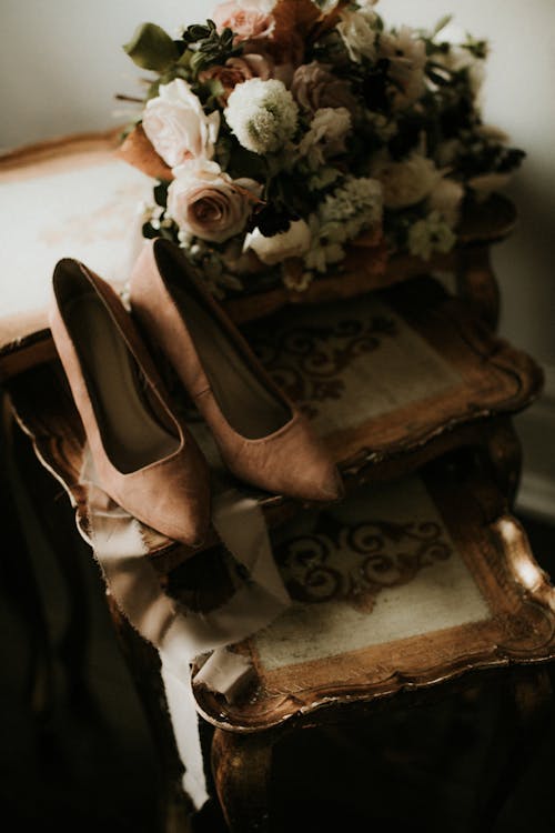 Free Bouquet Of Flowers And Shoes On A Table Stock Photo