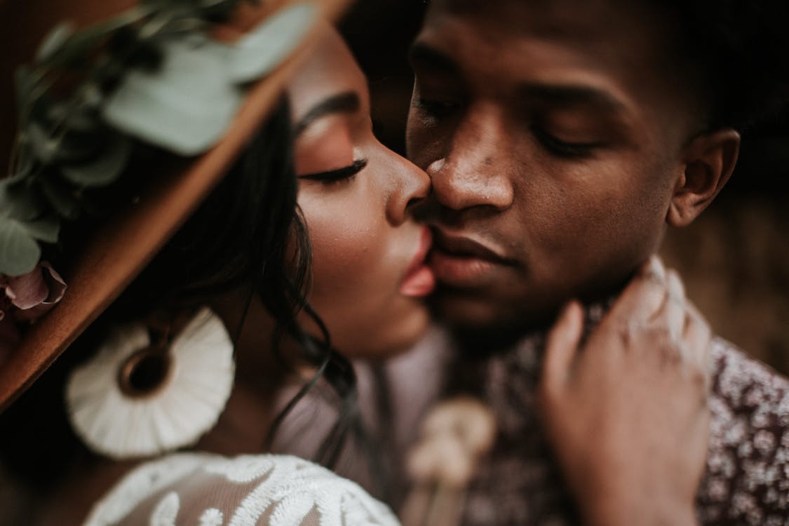 Close-Up Photo Of Man Kissing Woman 