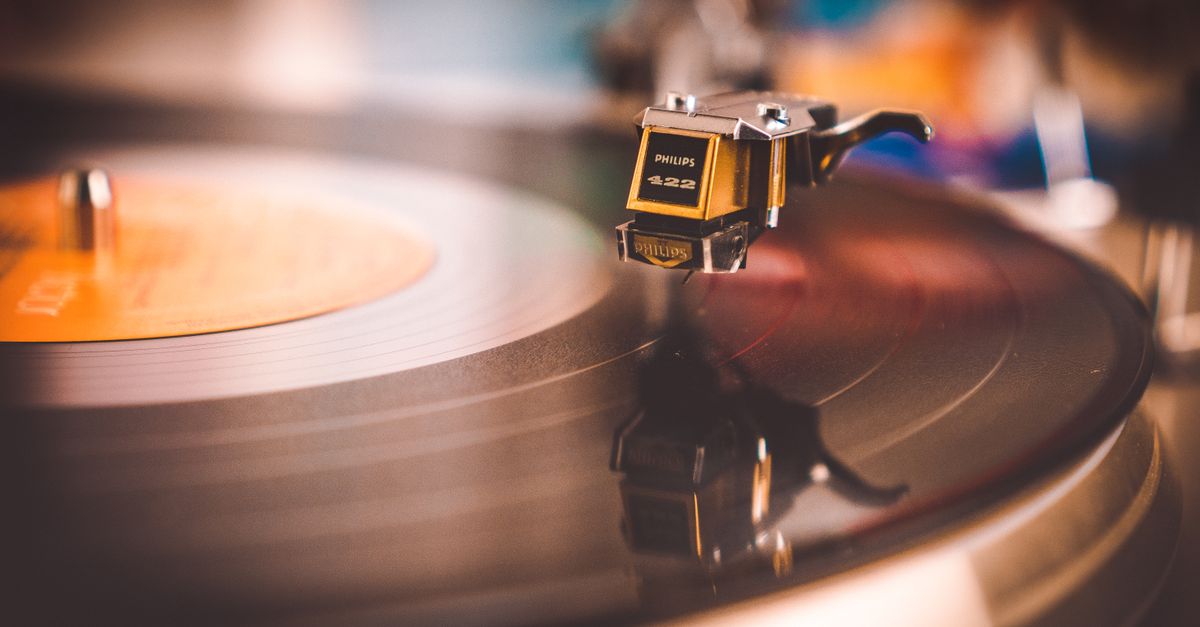 Close-up of a turntable needle dropping onto a spinning vinyl record