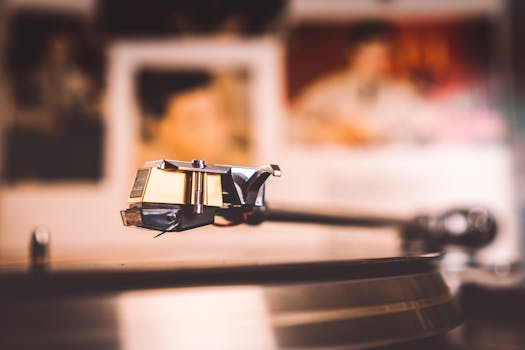 Close-up shot of a vintage vinyl record player needle with blurred background, emphasizing nostalgia.