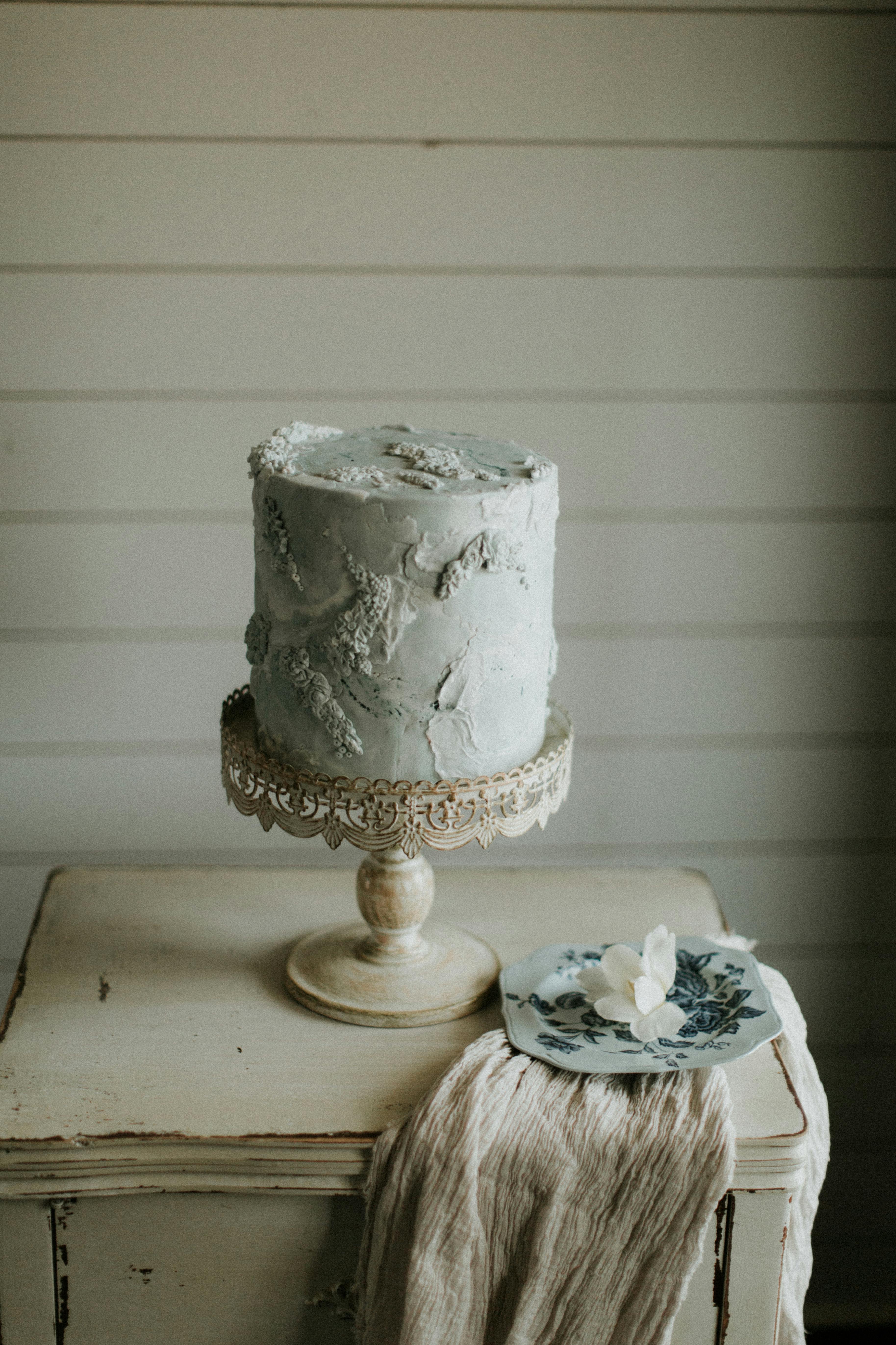 Rustic wedding cake on ornate stand