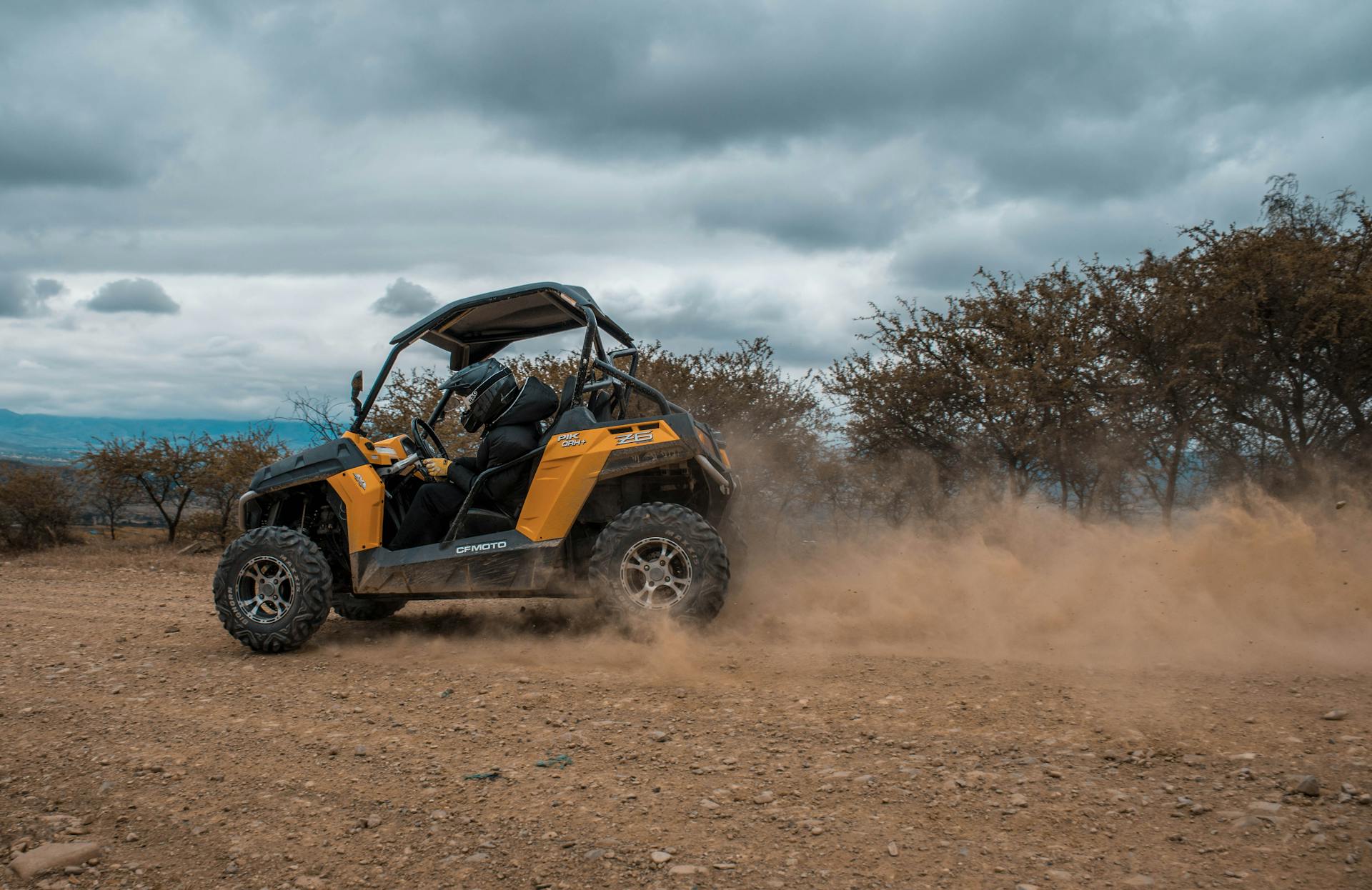 Experience the thrill of off-road driving with a quad bike in the dusty countryside.