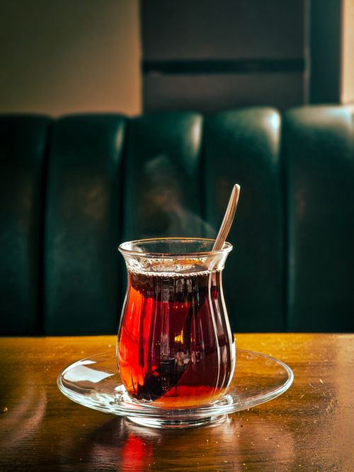 Free A warm cup of traditional Turkish tea in a glass on a wooden table indoors. Stock Photo