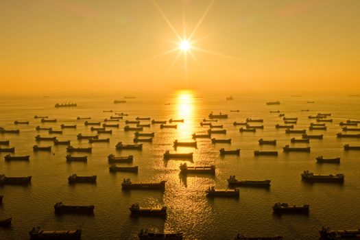 A stunning aerial shot of numerous ships at sunrise on Chattogram coast, Bangladesh.