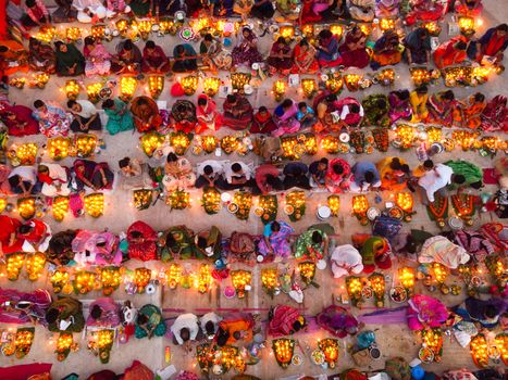 Aerial view of a colorful festival gathering with candlelight in Dhaka, Bangladesh.