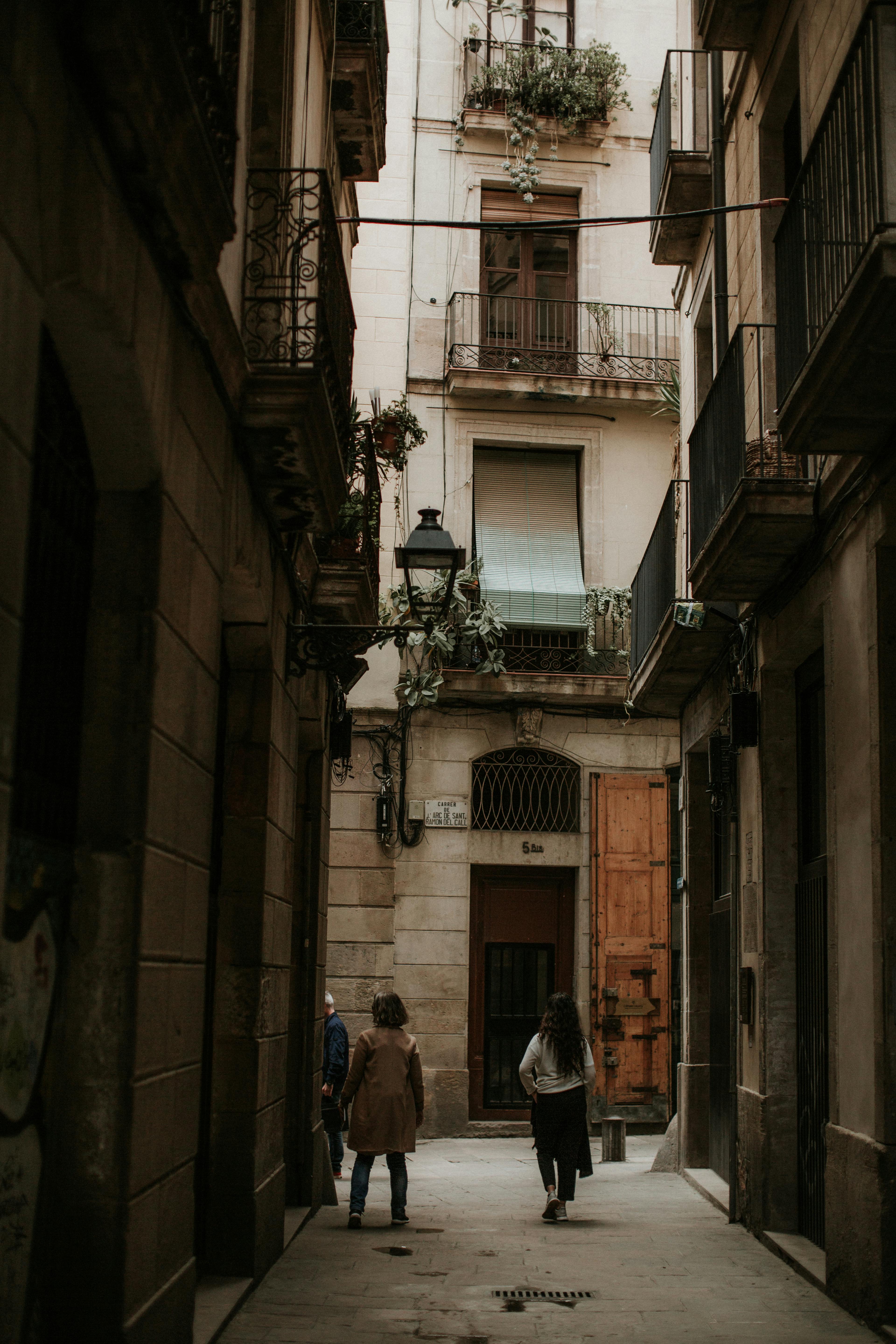 people walking in a narrow alley