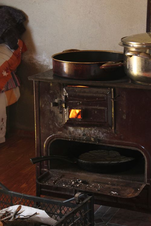 Free A cozy indoor scene with a rustic wood stove and cooking pots, adding warmth and nostalgia. Stock Photo