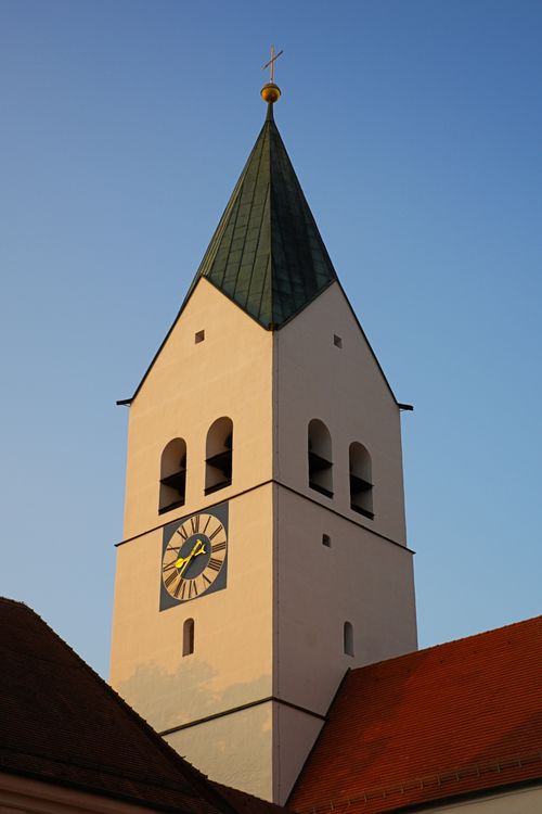 Free Charming Bavarian church tower with clock and steeple captured in warm evening light. Stock Photo