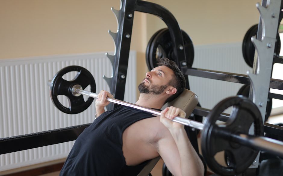 weightlifter performing heavy barbell bench press weightlifter performing heavy barbell bench press