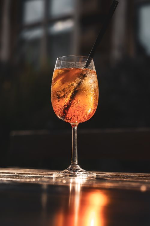 Free A chilled Aperol spritz with ice cubes, elegantly served outdoors with a warm glow. Stock Photo