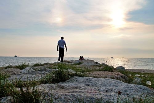 Free A serene seaside scene at Tanjung Kling, Malacca, showcasing a sunset over the rocky shore. Stock Photo