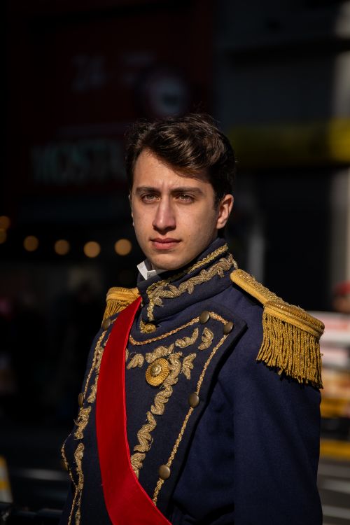 Free A man wearing a detailed historical military uniform with golden embroidery and red sash. Stock Photo