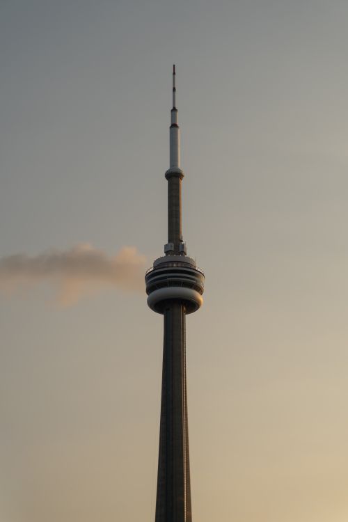 Free Dramatic view of the CN Tower silhouetted against a sunset sky in Toronto, Canada. Stock Photo