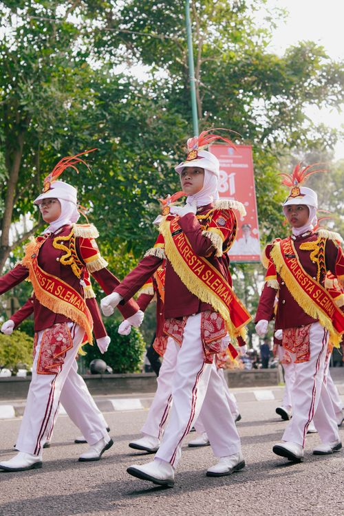 Free Marching band performance in colorful uniforms during an outdoor parade in Yogyakarta, Indonesia. Stock Photo