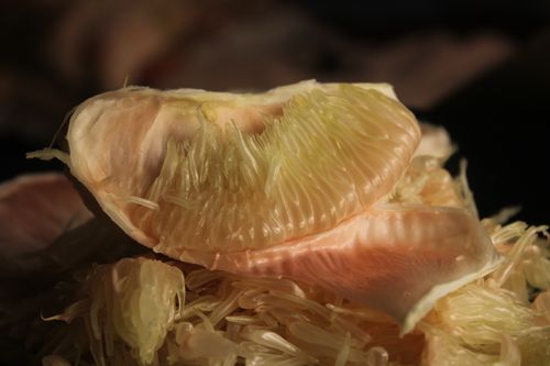 Free Detailed close-up of fresh pomelo fruit segments showcasing texture and color. Stock Photo