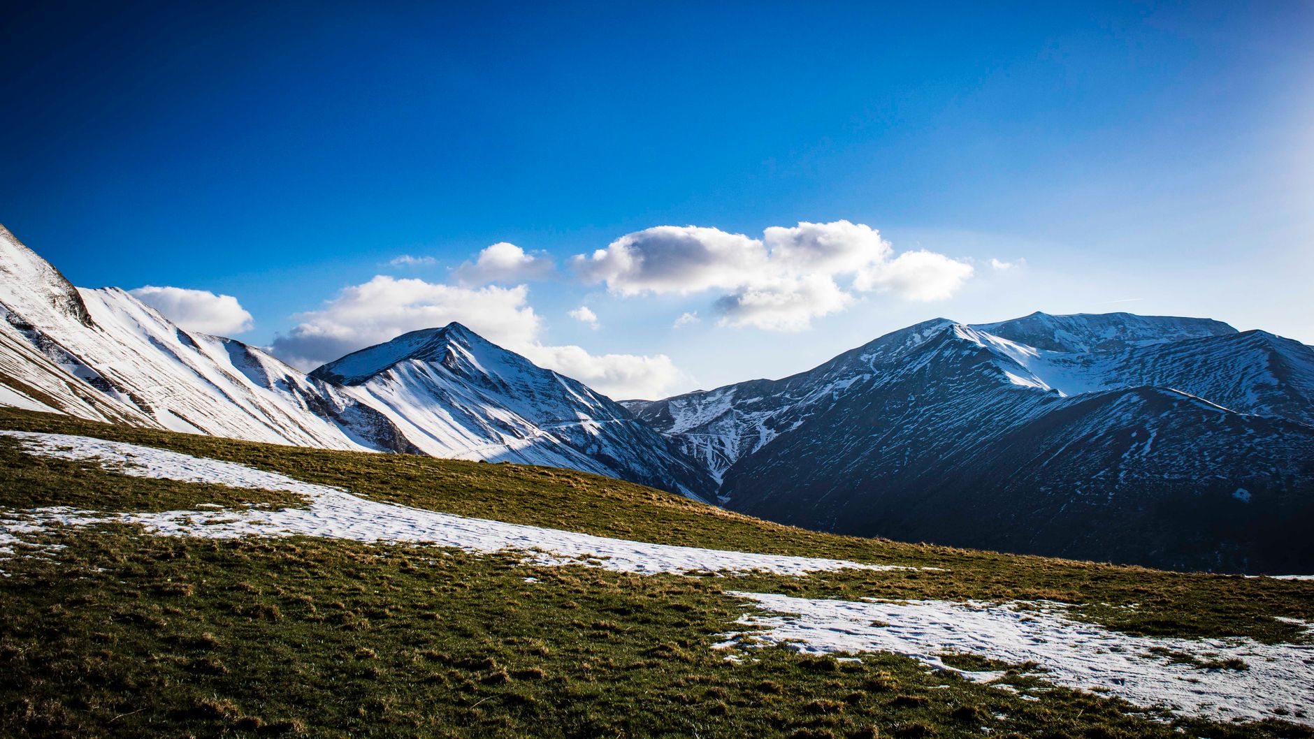 Captivating view of snow-capped mountains in Bolognola, Italy under a clear blue sky.