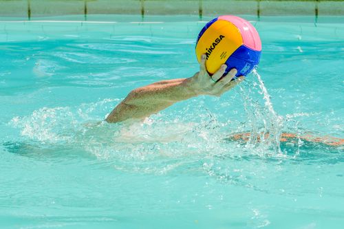 Free Dynamic water polo scene capturing the intensity of the game with vibrant colors and splashing water. Stock Photo