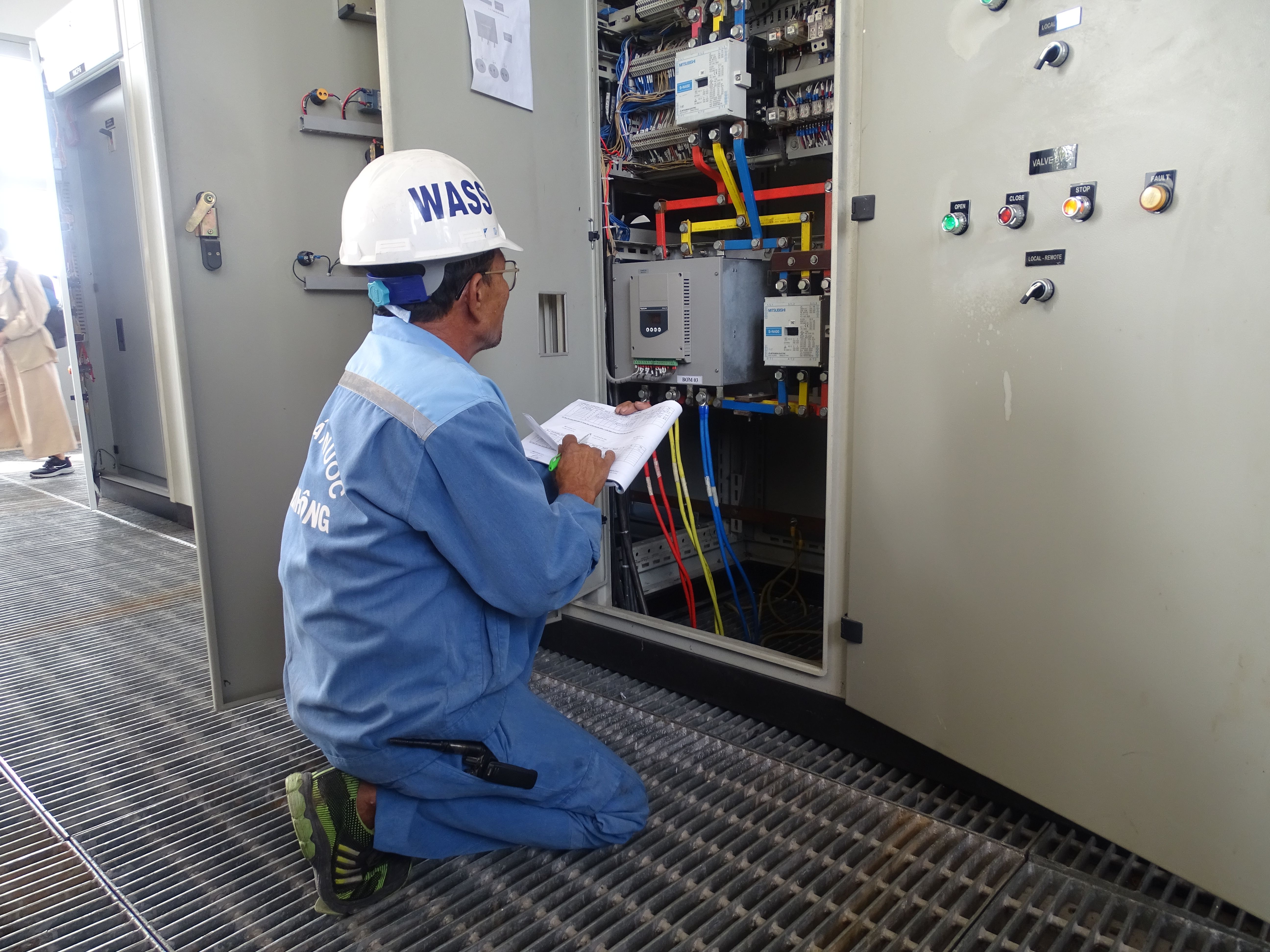 electrician checking documents on site