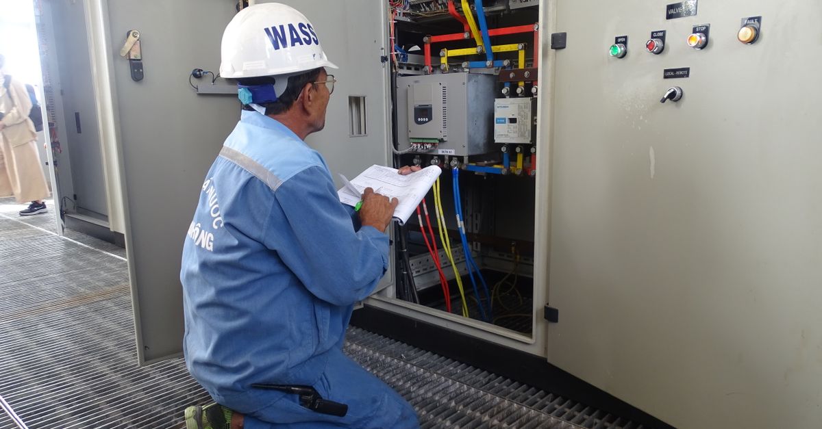 electrician checking documents on site