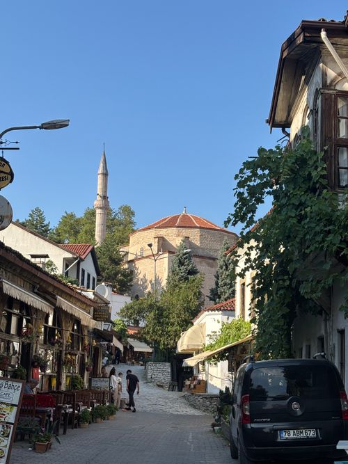Free Explore an enchanting Ottoman street featuring a historic mosque and quaint local shops. Stock Photo