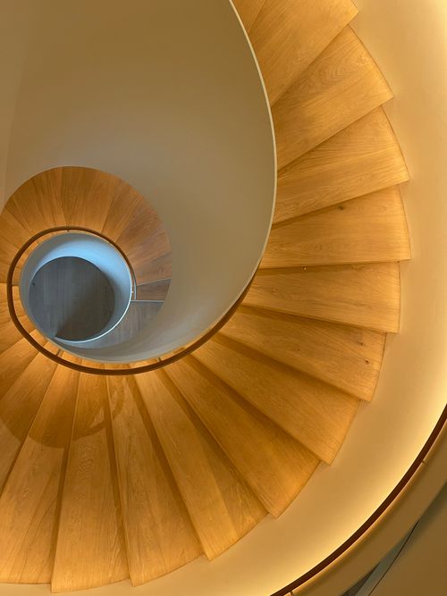 Free A stunning view of a spiral staircase with wooden steps in Düsseldorf, Germany. Stock Photo