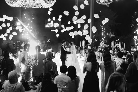 Black and white photo of a stylish and elegant wedding celebration with a dancing couple in Antalya, Turkey.