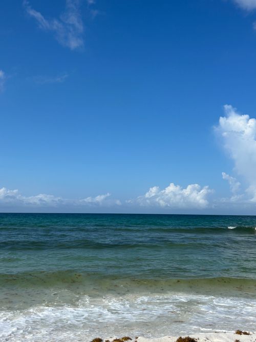 Free Tranquil view of the emerald waters and blue sky at a Florida beach. Stock Photo