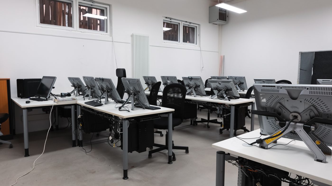 Computer lab with rows of desks and monitors