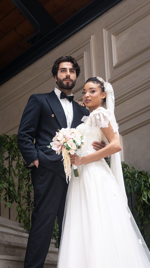 Free Stylish indoor portrait of an elegant bride and groom in wedding attire, exuding timeless romance. Stock Photo