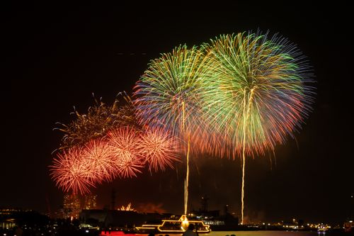 Free Vibrant fireworks light up the night sky over Yokohama Bay, Japan, creating a dazzling spectacle. Stock Photo