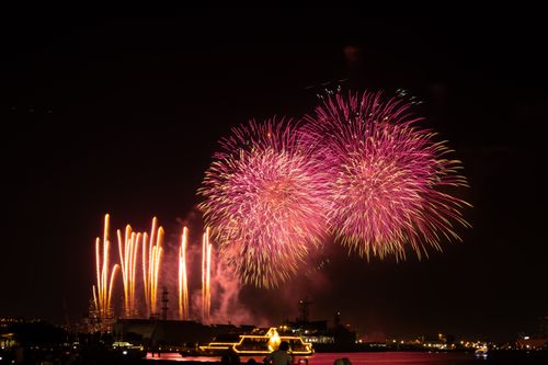 Free Vibrant fireworks illuminate the night sky over Yokohama Bay, Japan. Celebration and festivity captured. Stock Photo