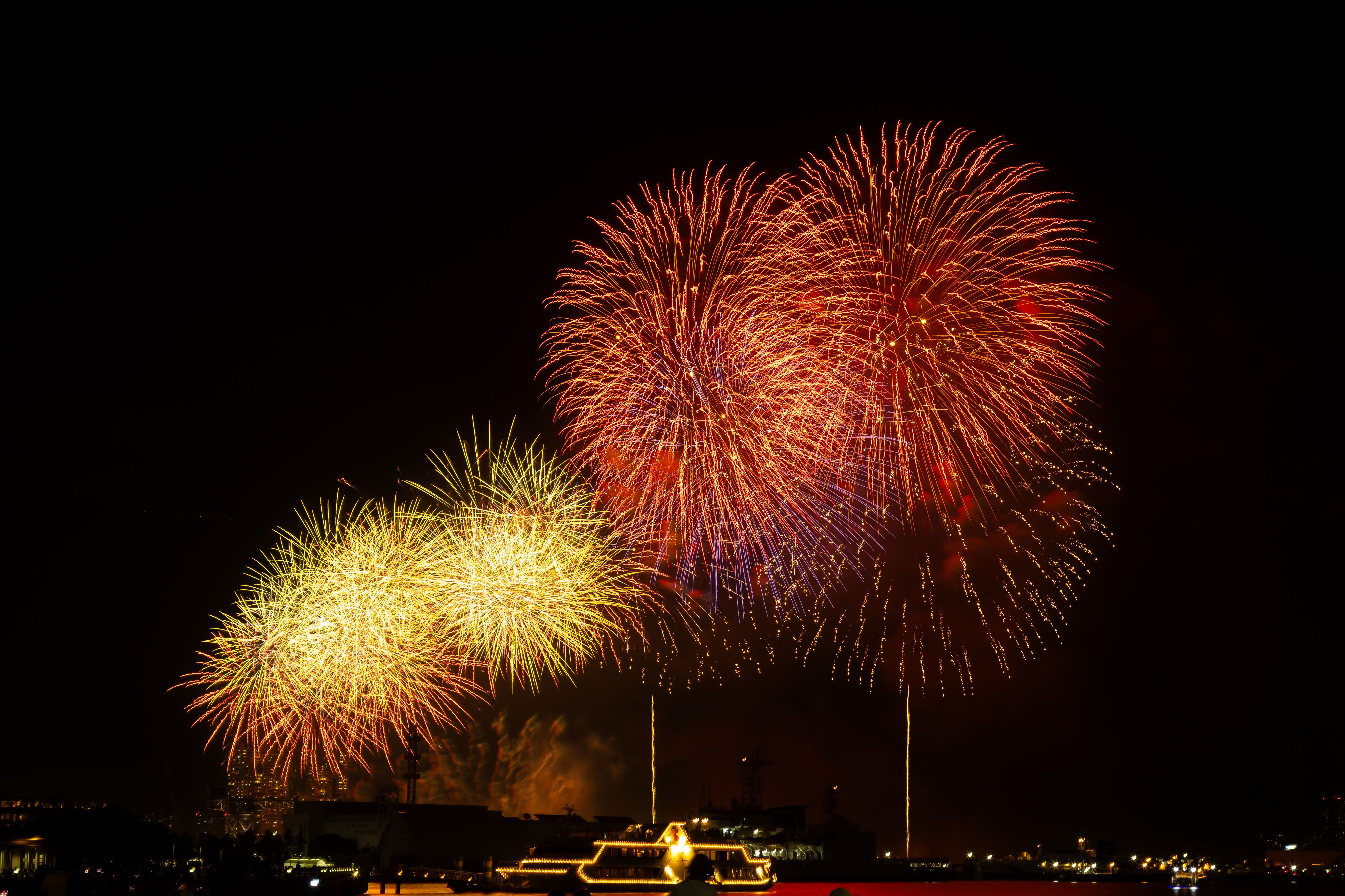 Stunning fireworks illuminating the night sky over Yokohama Harbor in Japan, showcasing vibrant colors and celebration.